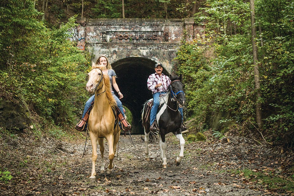 People horseback riding at Moonville Tunnel