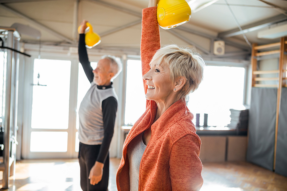 Elderly couple using kettle bells