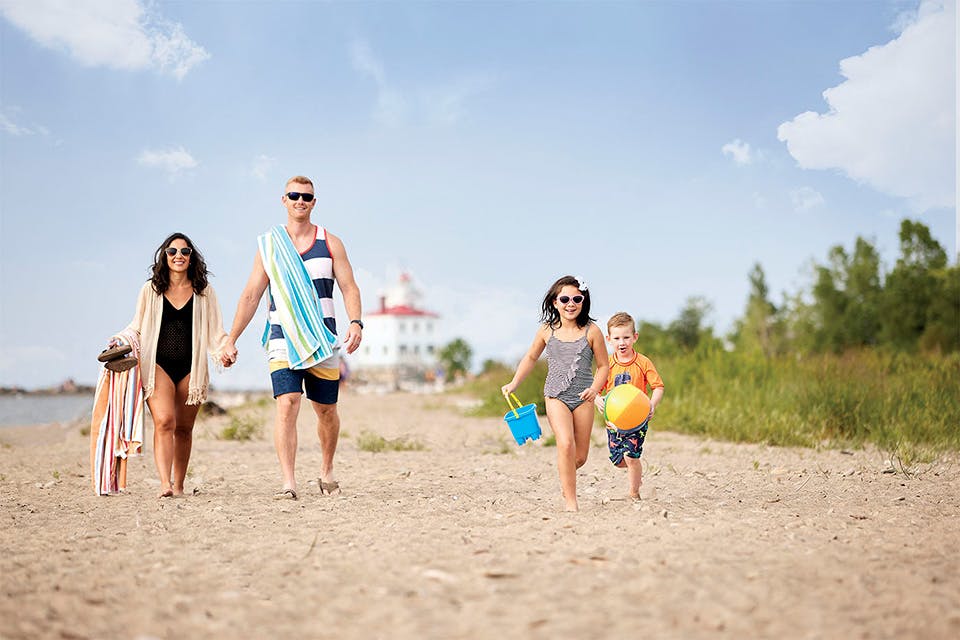 Family walking at Mentor Headlands Beach