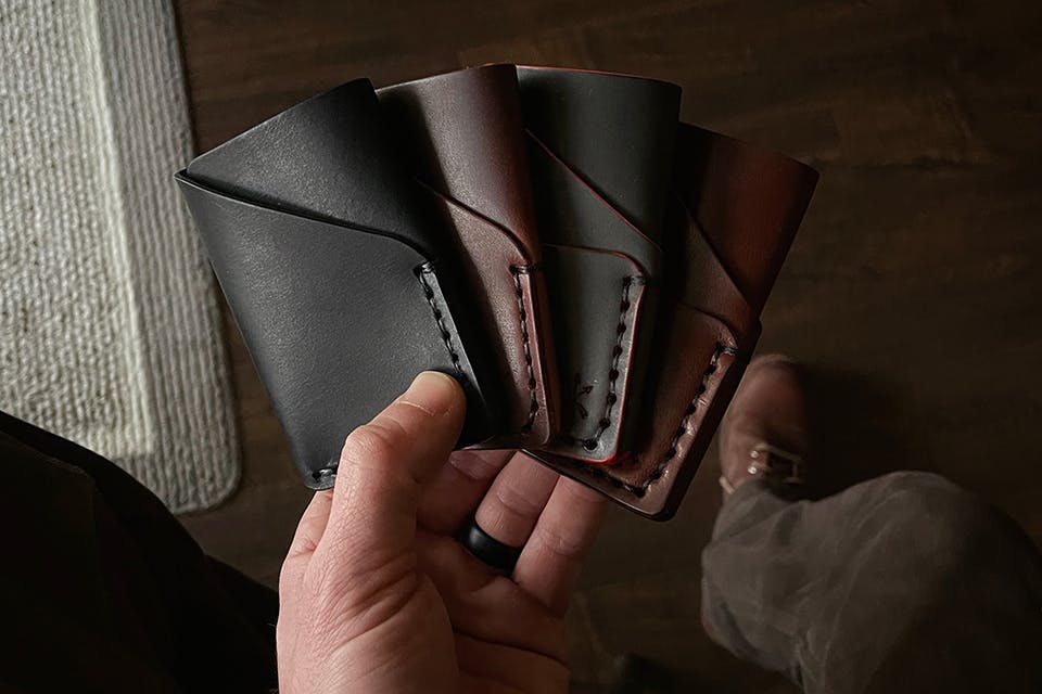 Man holding four Three Sons Leather Co. wallets (photo courtesy of Three Sons Leather Co.)