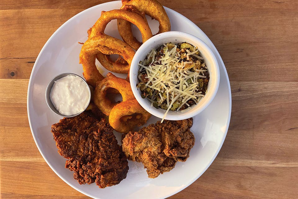Fried chicken with Brussels sprouts and onion rings at Park’s Place in Amesville (photo courtesy of Park’s Place)