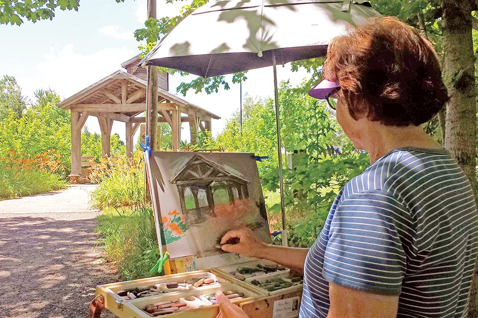 Women painting covered bridge at Plein Air Gathering in Hancock County (photo courtesy of Plein Air Gatherings)