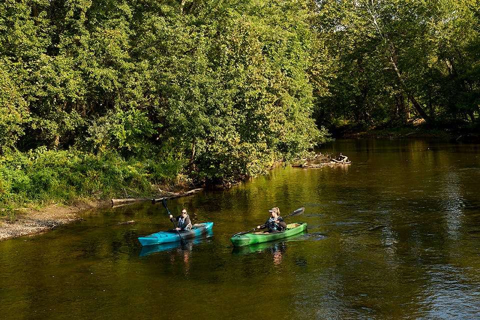 Two people kayaking on the Cuyahoga River in Cuyahoga Falls (photo by Kevin Kopanski)