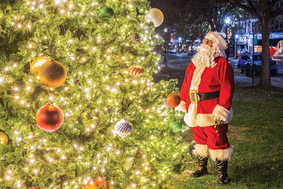 Santa Claus looking at Christmas tree at Marietta’s First Friday: Moonlight Madness (photo courtesy of Marietta Washington County Convention & Visitors Bureau)