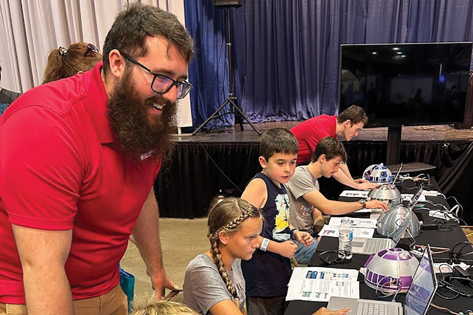 Kids work on programming the R2 D2 mini domes at the Ohio State Fair (photo courtesy of Southern State Community College)