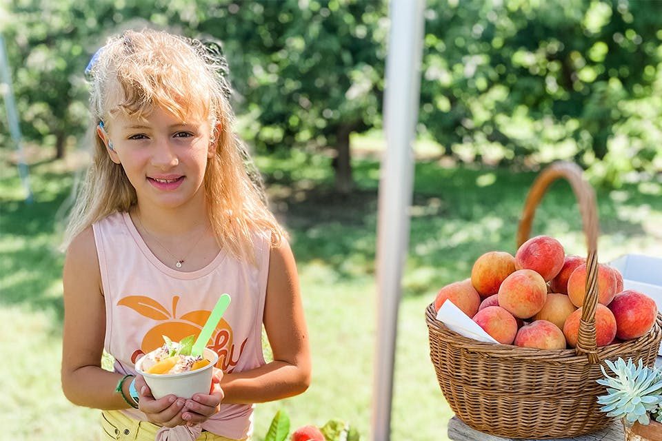 Child with ice cream at Peaches and Cream (photo courtesy of Quarry Hill Orchard)