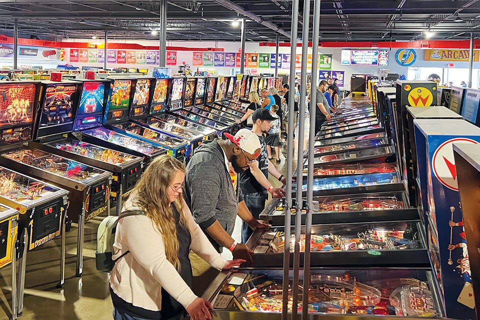 People playing pinball at Past Times Arcade (photo courtesy of Past Times Arcade)