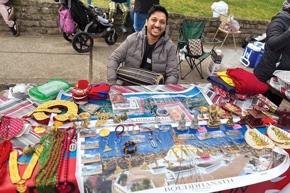 Man at vendor booth at Athens’ Ohio University International Street Fair (photo courtesy of Ohio University)
