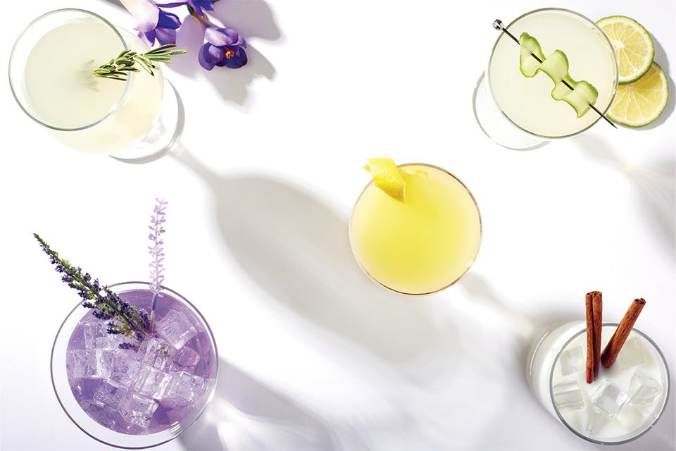 Five colorful, herb infused cocktails against white backdrop (photo by Kevin Kopanski)