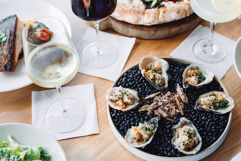 Oysters, greens, salmon, pizza and cocktails at Summer Place in Lakewood (photo courtesy of Summer Place)