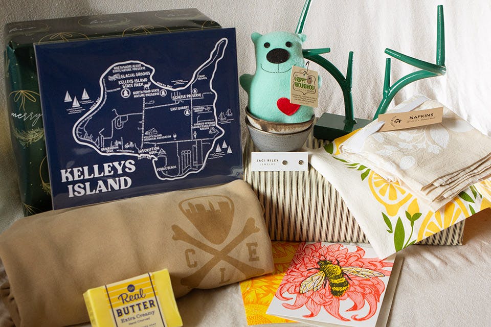 Kelleys Island map from Whereabouts Shop, animal by the Happy Groundhog Studio, stand by Echo Hill Forge, shirt from CLE Clothing Co., studs from Jaci Riley Jewelry, towels from Hazelmade, soap from Whiskey River Soap and card from Just A Jar Design Press