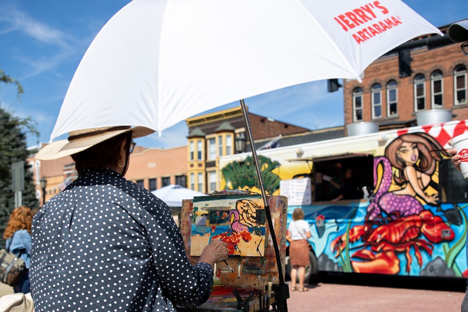 Man painting at Holmes County Art Festival in Millersburg (photo courtesy of Historic Downtown Millersburg)