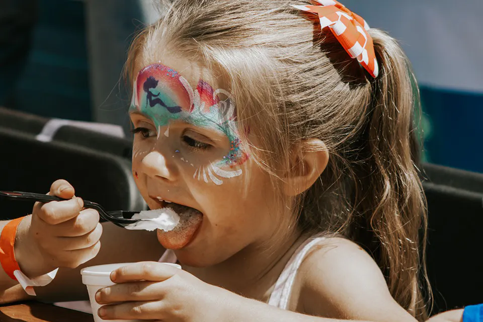 Girl eating ice cream (photo courtesy of Utica Ice Cream Festival)