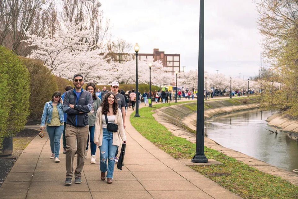 People walking along Lock 3 in Akron during Downtown Akron Sakura Festival (photo courtesy of Akron/Summit Convention & Visitors Bureau)