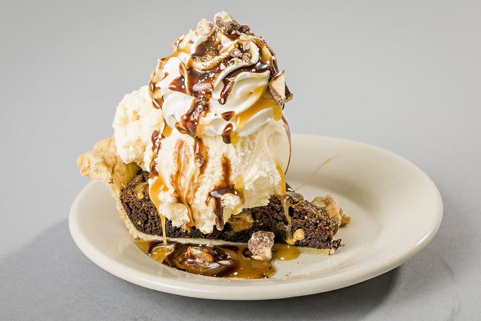 Nutcracker snickers pie covered with ice cream and toppings